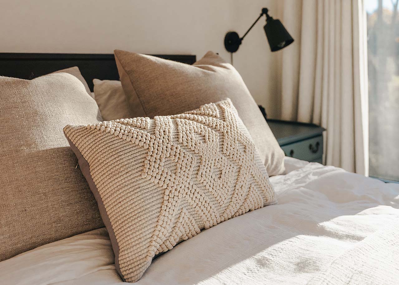 cosy pillows on a bed - the slow living guide blog category home & cosy