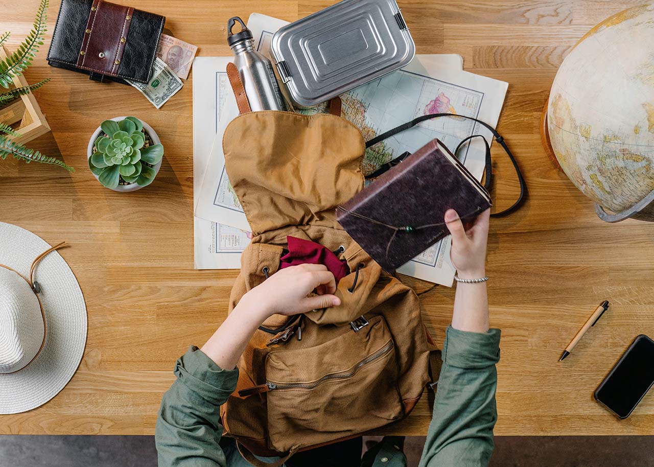 a woman on a bed with a laptop, holding a cup of coffee - next steps to future-proof your small business