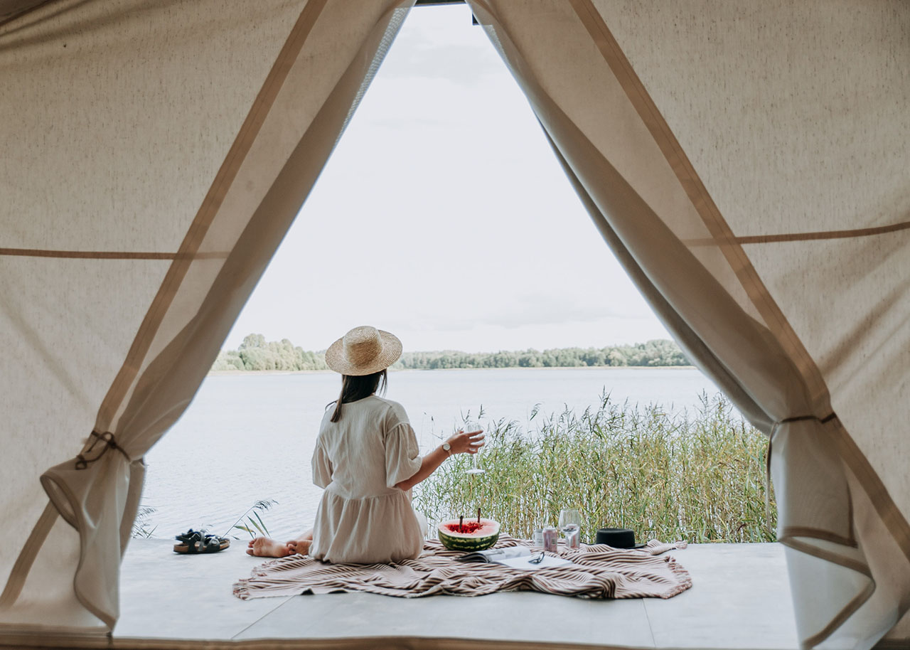 a woman on a bed with a laptop, holding a cup of coffee - next steps to future-proof your small business