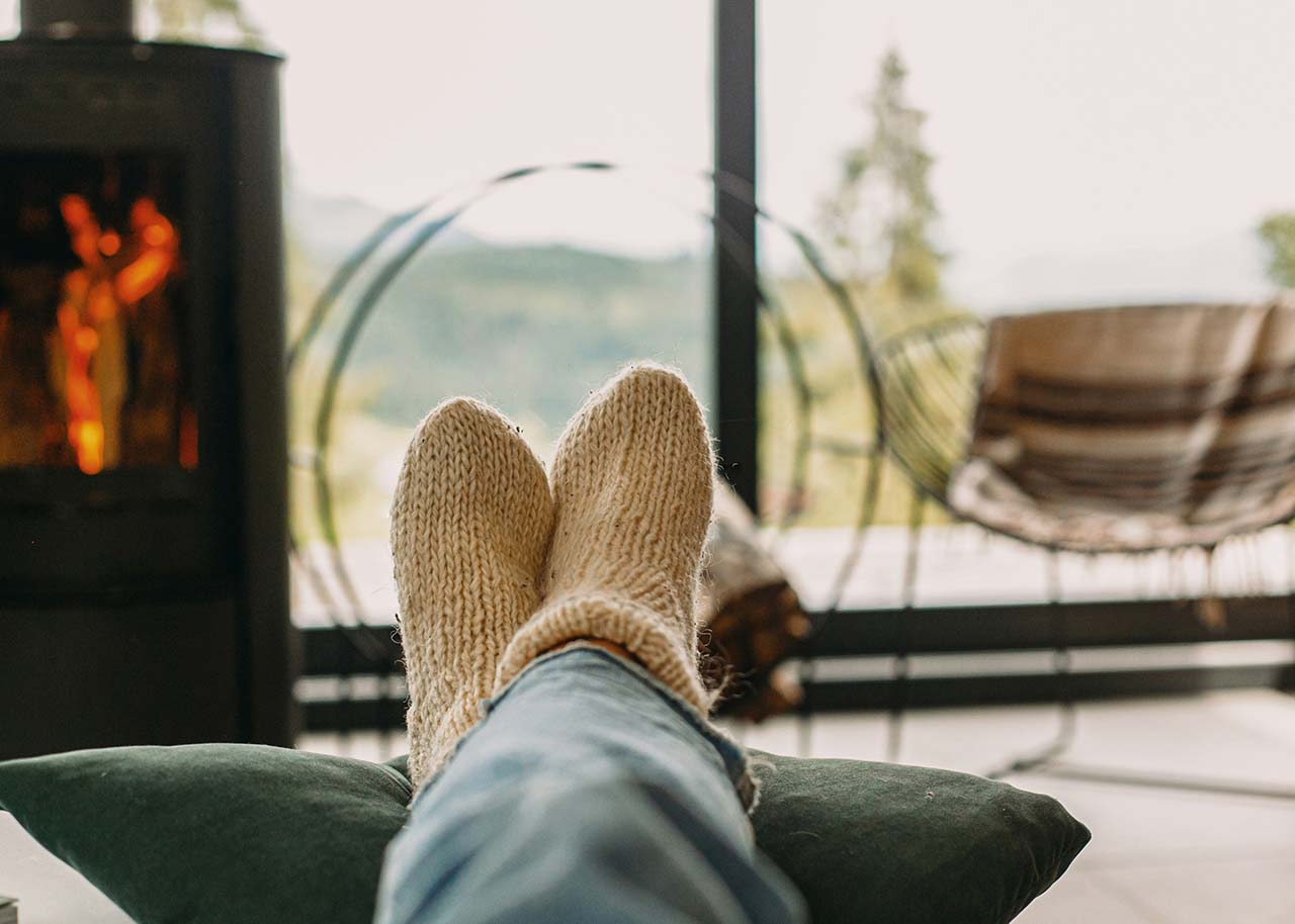 a woman on a bed with a laptop, holding a cup of coffee - next steps to future-proof your small business